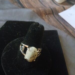 Silver ring with white with black specks
